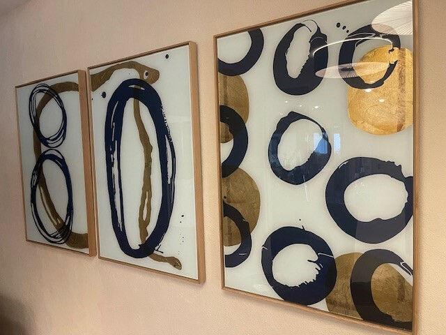 Three-part abstract artwork with blue and golden circles.