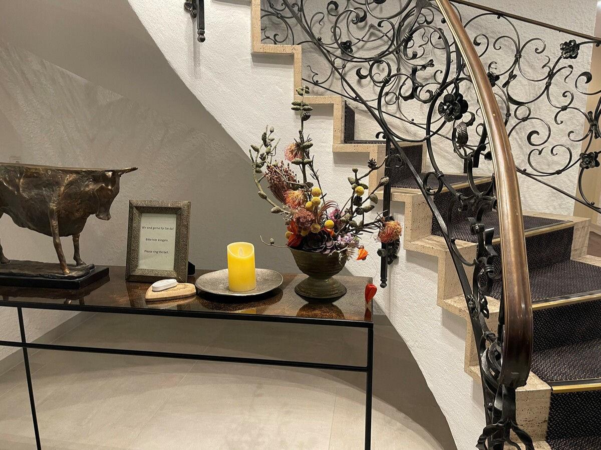 Staircase with a bronze bull and wrought-iron banister.